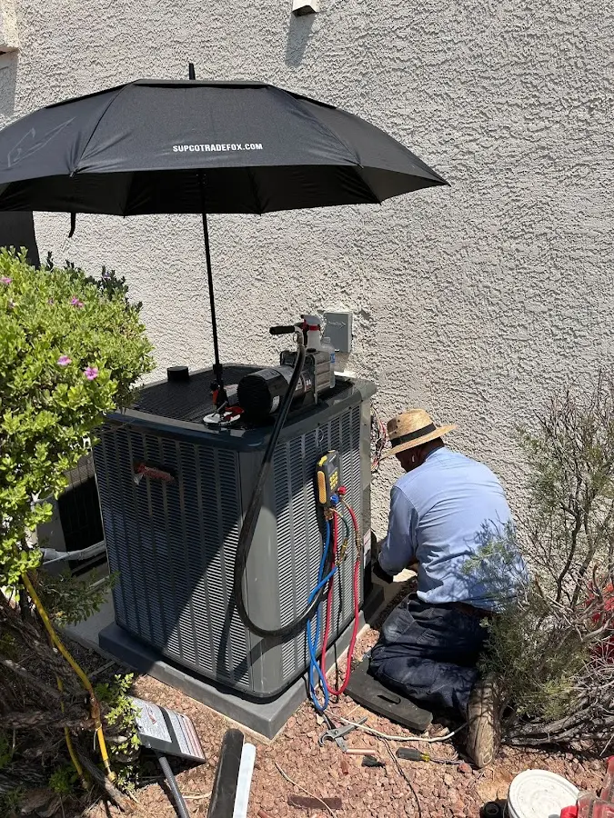 HVAC technician performing outdoor AC maintenance in South Strabane