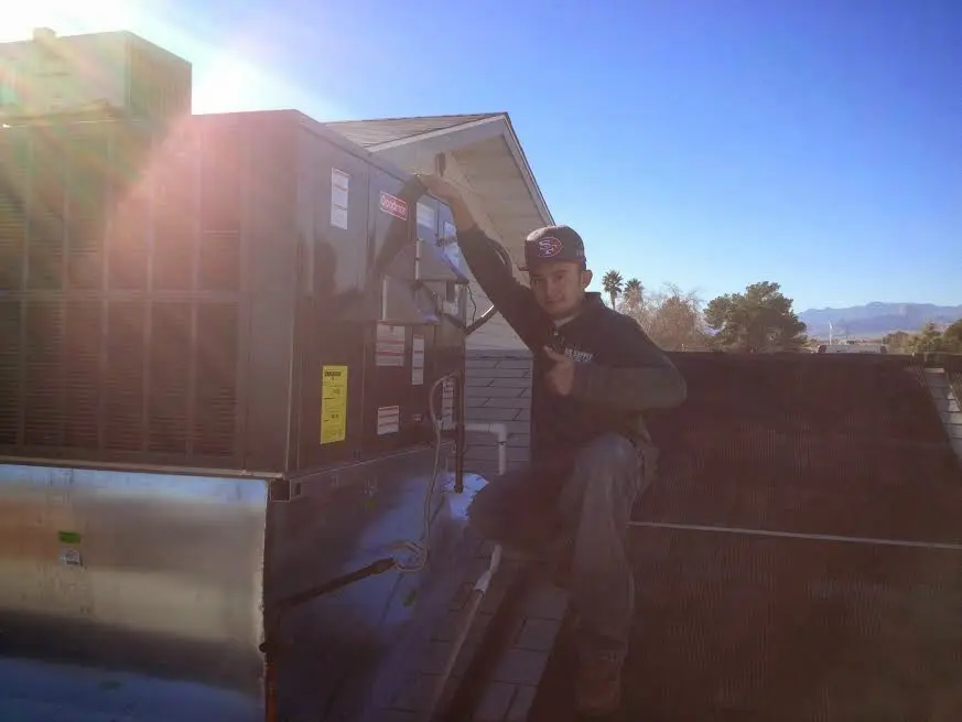 HVAC technician performing AC Tune-Up on a rooftop unit in South Strabane